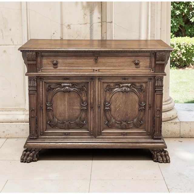 A French Louis XIV buffet hand carved from quarter-sawn white oak, its honeyed patina revealing the shimmering ray fleck...