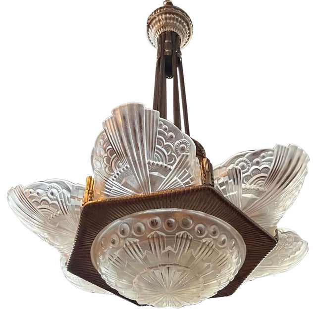 DETAILS A vintage chandelier with a cast, frosted white, bowl from glass shade encircled by six slipper shades each molded...