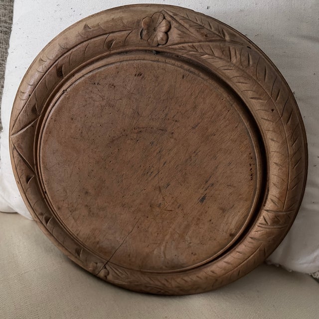 Small floral design and other carvings in this unique bread board Can also be hung on the wall