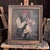 A charming late 19th-century genre oil painting depicting an elderly woman playfully startling a crying child. Signed C....