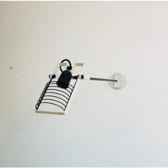 Beautiful Italian wall lamp by Ernesto Gismondi for Artemide. Metal body with adjustable head. It has an extraordinary...