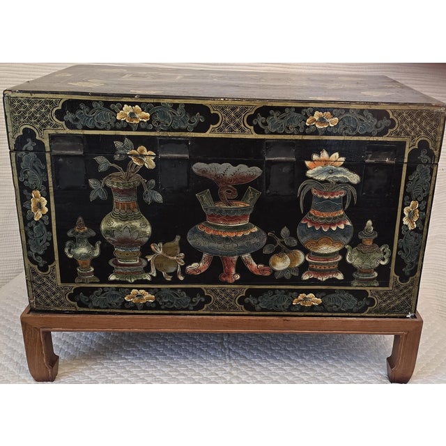 This 19th century Chinese export lacquer chest features finely painted figural garden scenes with scholars beneath...