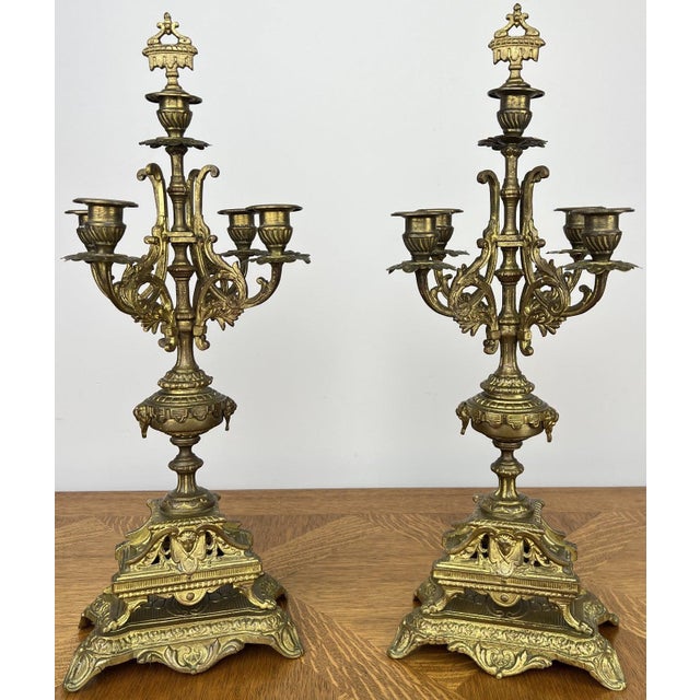 An elegant antique brass candelabra set with richly decorative detailing and an impressive classical presence. Featuring...