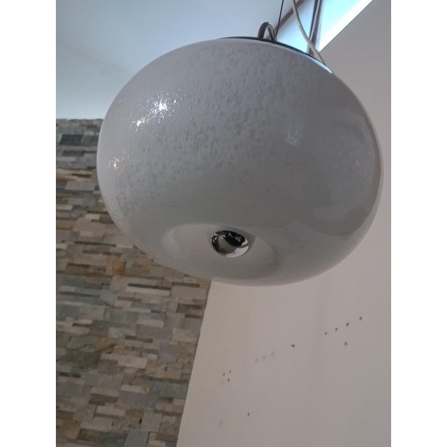 Magnificent pendant lamp by Mazzega. Italy, 1970s. Chrome-plated metal frame. It supports a large Murano blown glass...