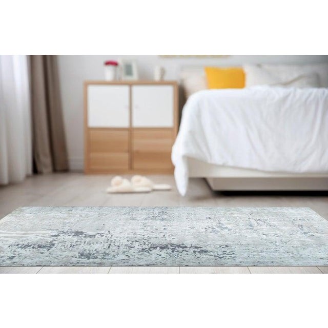 This machine made area rug features a primary gray color palette and is constructed from durable wool fibers. Designed in...