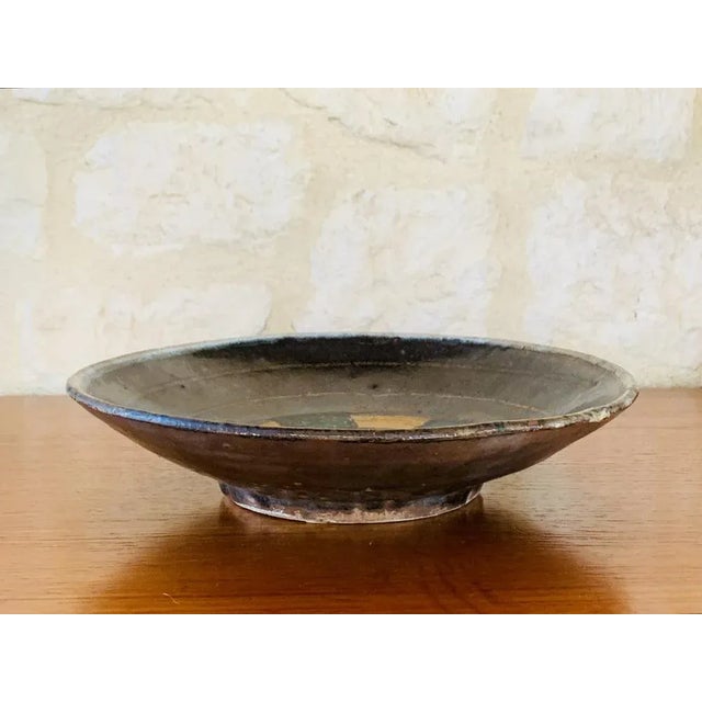 Mid-century, vintage, glazed, multicolored, decorative earthenware bowl from California, circa 1960’s. The bowl has a...
