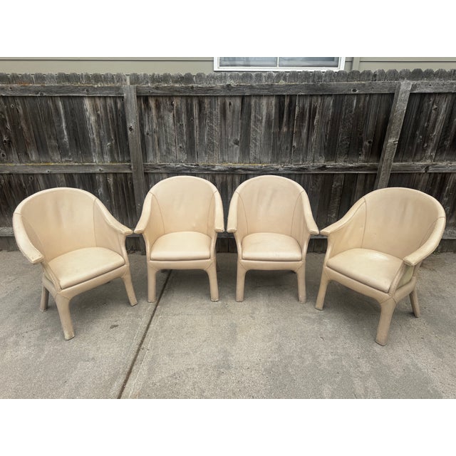 A striking and rare set of four vintage barrel-back armchairs, attributed to celebrated Filipino designer Antonio "Budji"...
