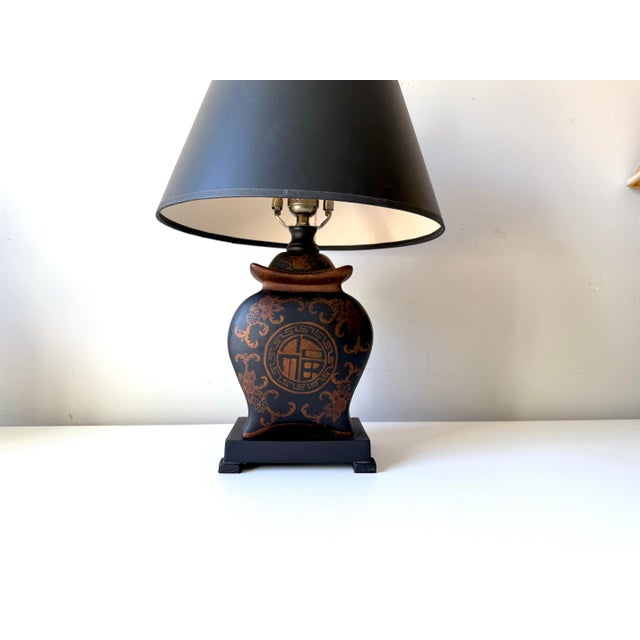 Vintage black Pagoda table lamp with vintage black empire lampshade. This piece is hand painted with bronze-gold details.