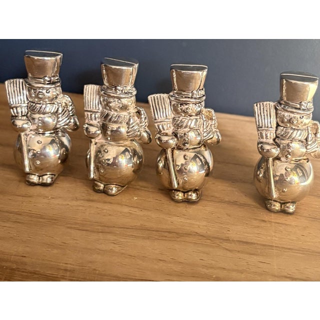 A set of four figural snowman place card holders by International Silver Company, finished in bright silverplate. Late...
