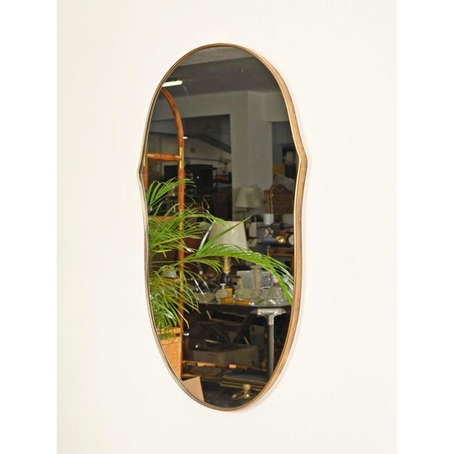 Stunning free-form organic mirror with a solid brass frame. This incredibly elegant piece was produced in Italy during the...