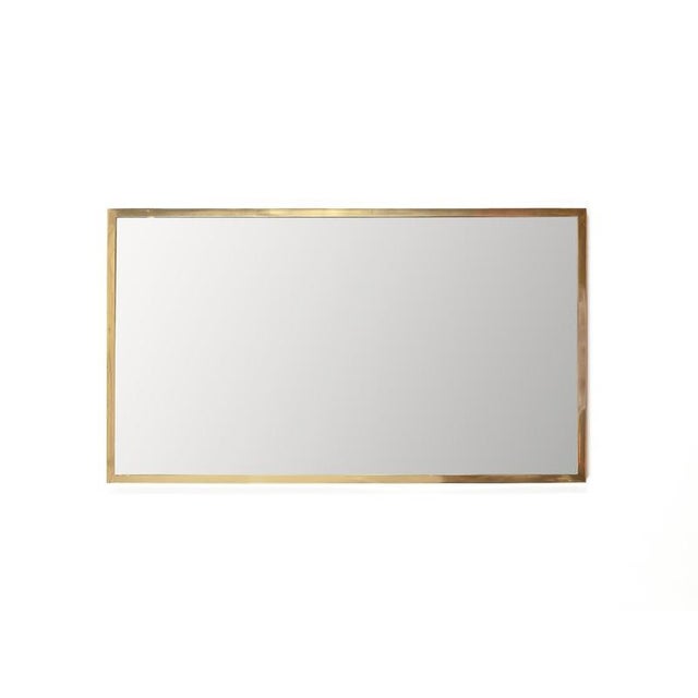 Wonderful large Italian rectangular mirror with a solid brass frame. This elegant mirror was produced in Italy during the...