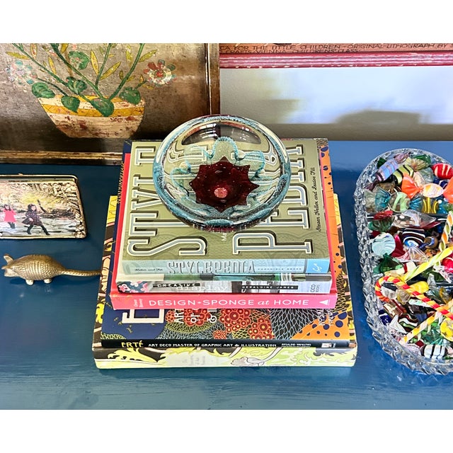 Striking hand-blown art glass bowl featuring a vivid sommerso-style magenta floral core encased in clear glass with...