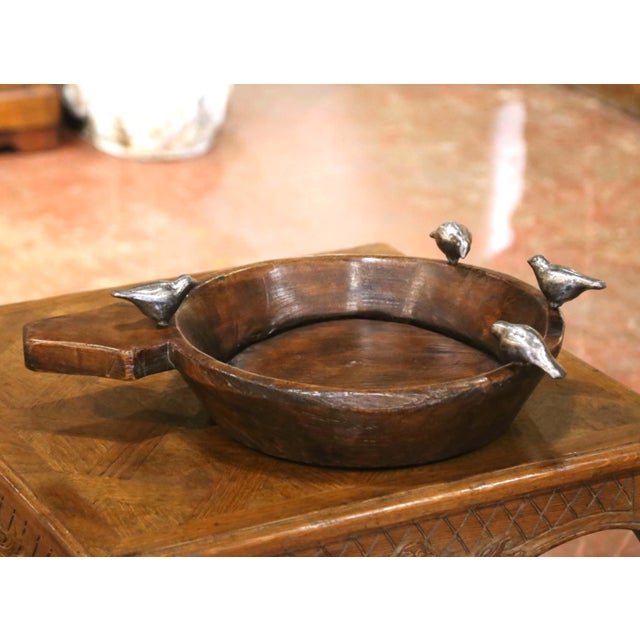 Sculptural and rustic, this decorative serving bowl by Jan Barboglio combines hand-carved wood with whimsical cast iron...