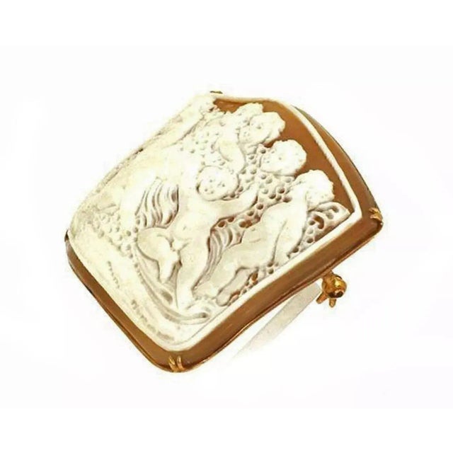 This is a lovely vintage brooch or pendant. Crafted from 18k pink gold it features a group of cherubs shell cameo set in...