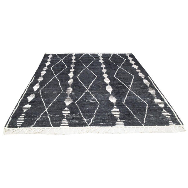 Hand-knotted with care using traditional rug-making techniques, this wool rug blends timeless craftsmanship with a modern...