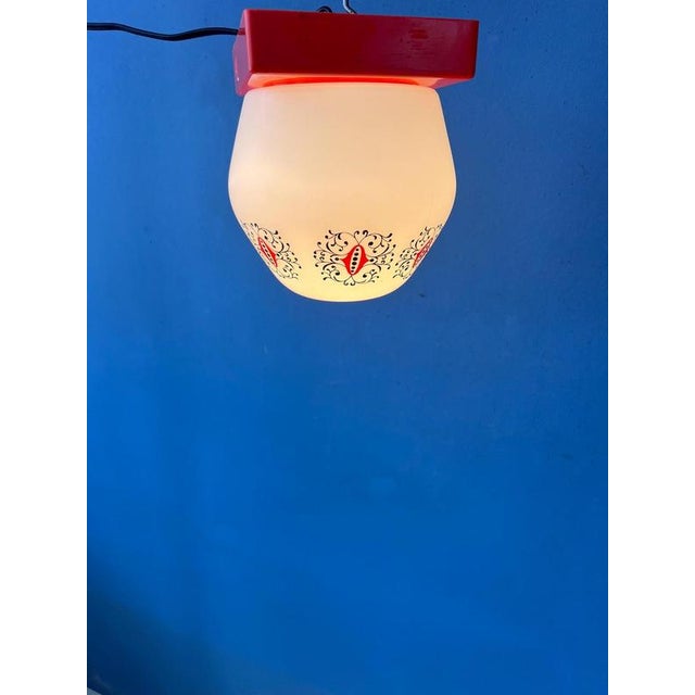 Rare vintage Thabur ceiling lamp featuring a beautiful opaline glass shade paired with a vibrant orange ceiling canopy....