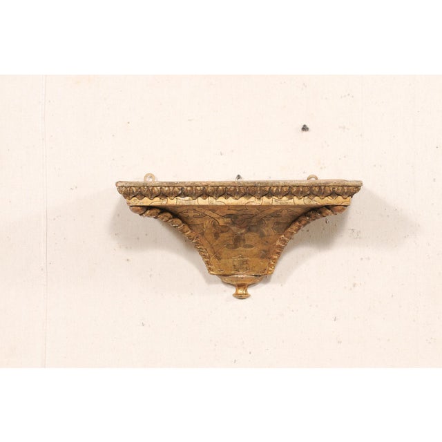 A French carved and gilt wood shelf bracket from the turn of the 18th and 19th century. This antique architectural wall...