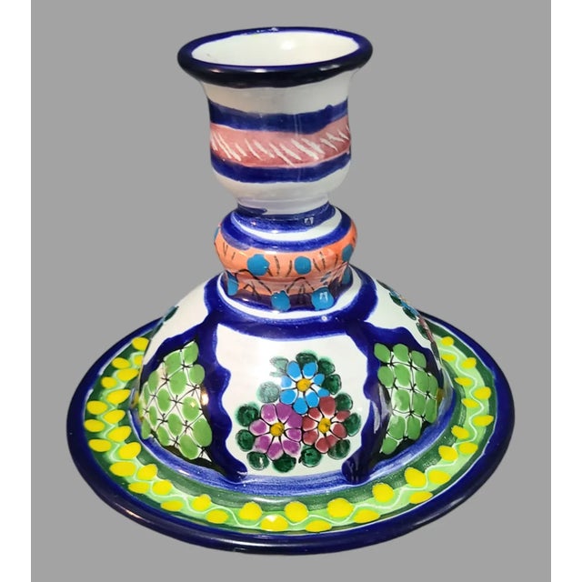 Add a touch of Mexican charm to your home decor with this vintage hand-painted candle holder. The colorful terracotta...