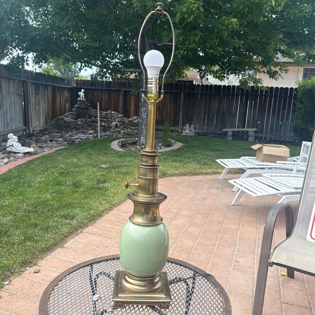 This lamp is a Stiffel "Ostrich Egg" table lamp, a highly collectible piece known for its Hollywood Regency style and...
