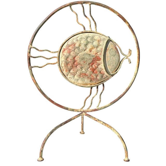 Unusual vintage fish sculpture featuring a handcrafted iron framework with expressive wavy fins, curved supports, and an...
