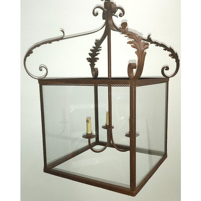 Simple and elegant extra large iron hanging lantern with Spanish influenced details. Glass sides with open bottom and...