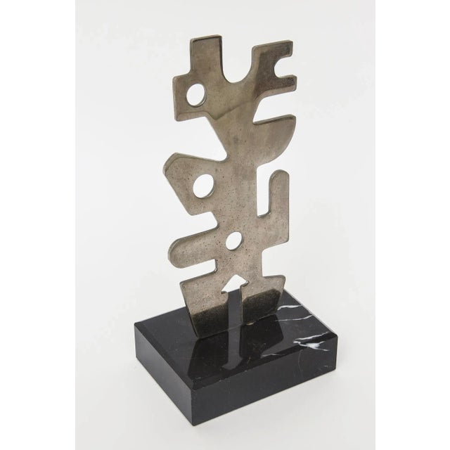 This vintage modernist cubist style steel metal sculpture sits on a black veined marble base that is original. It is...