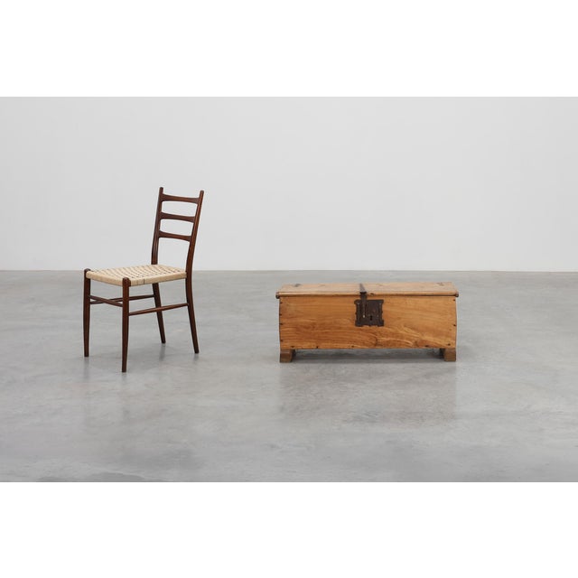 A charming French rustic chest from around 1900, crafted in solid oak with a warm, natural patina. The piece features a...