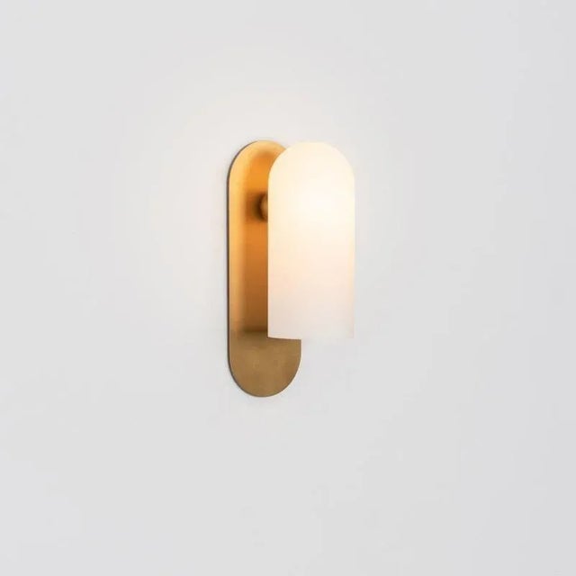 Brass medium sconce by schwung. Dimensions: w 10.5 x d 14 x h 30.5 cm. Materials: brass, frosted glass. Finishes...