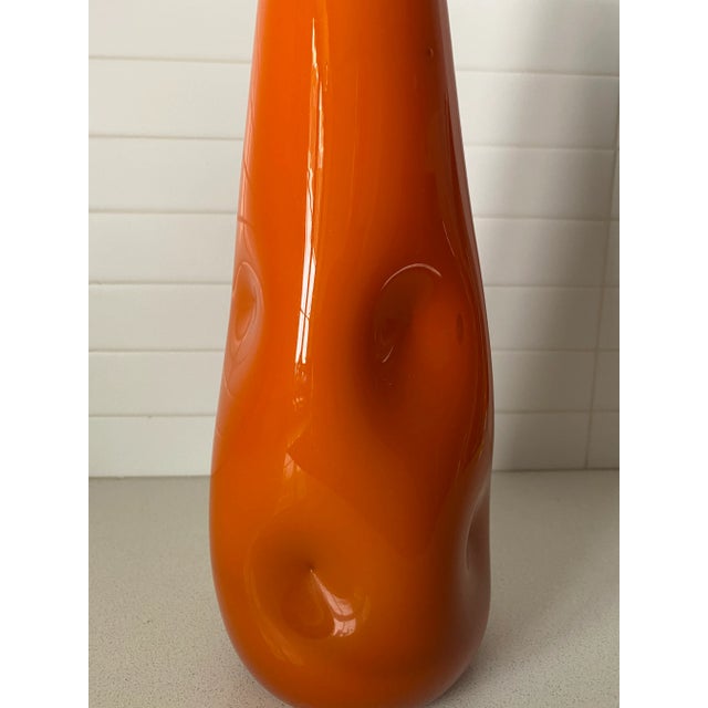 This hand blown and hand crimped cased glass bottle showcases the artist's hand throughout this piece. You can fully sense...