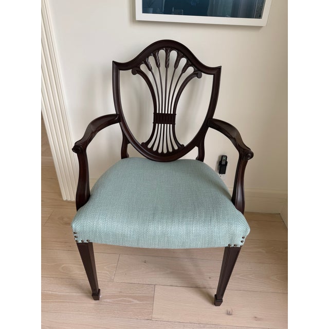 Eight chairs are a matching set and are upholstered in a Schumacher cotton tweed with brass nailheads.