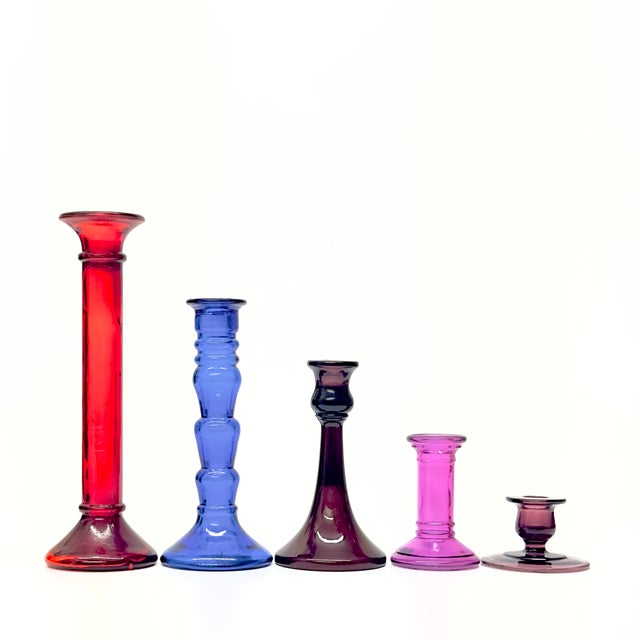Jewel-toned candle holders, group of 5. This is a glamorous assortment of jewel-toned glass candle holders featuring a...