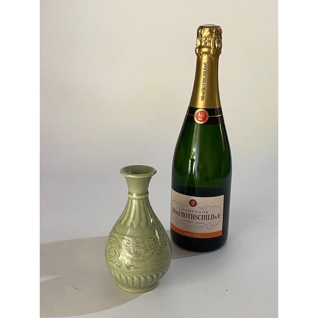 Green Celadon vase. This ceramic was made in China in the 20th century. It is small in size and has decorations in the...