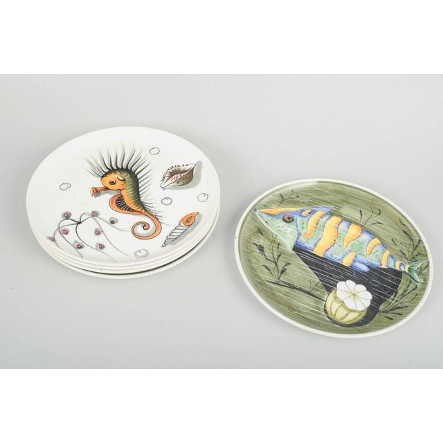 Mancioli, Italy 5 faience plates, 1960s. Set of five hand-decorated faience plates with colourful motifs and classic...