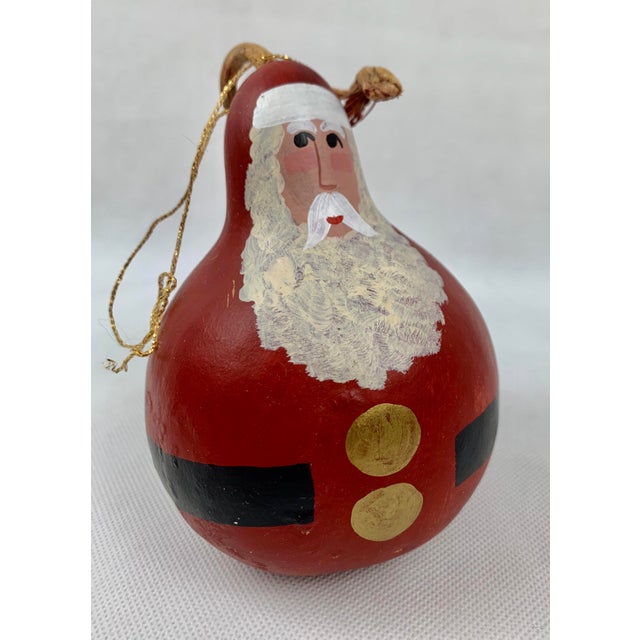 Red Santa with the epitome of Merry Christmas in his sweet expression painted by A. Hay in 1991. This ornament is in great...