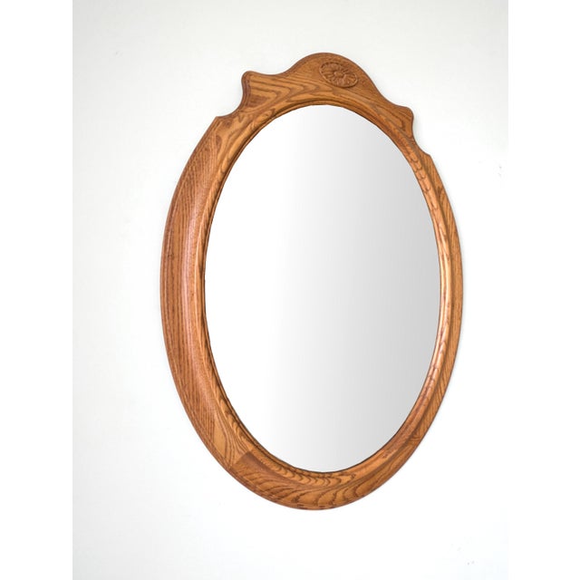 A vintage wall mirror featuring solid oak wood frame and beveled edge glass mirror. Ready to hang!