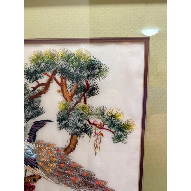Vintage Chinese silk embroidery featuring peacocks among flowering branches, executed in fine multicolored thread on a...