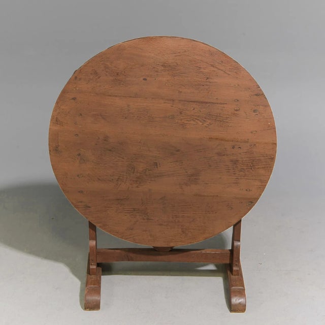 A charming French tilt-top vendange (wine) table with a classic round top and folding base. Traditionally used during the...