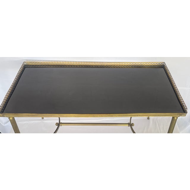 Just in, This Neoclassical French Black Glass Gallery Cocktail Table Attributed to Maison Jansen, 1940 This classically,...