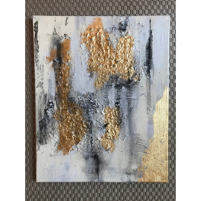 Add a splash of glam to your space! This pair of mixed media abstract paintings are adorned with gold leaf and textiles....