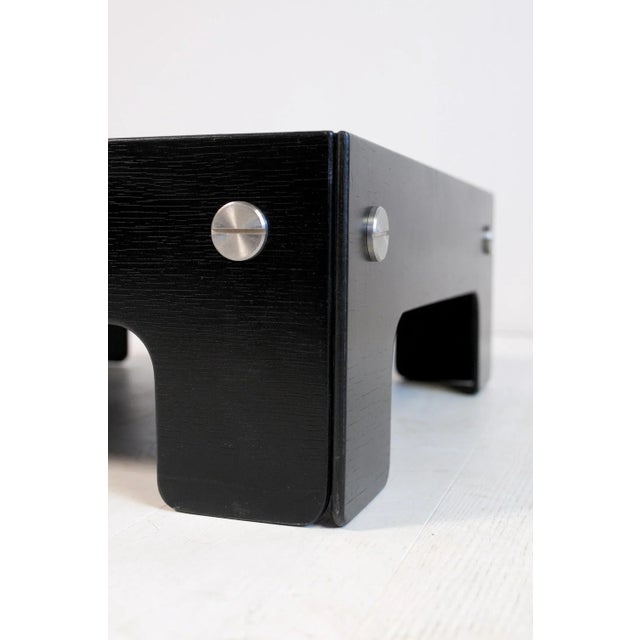 - Coffee table in black lacquered plywood, enhanced by large stainless steel screws - By John Hardy, distributed by Formes...