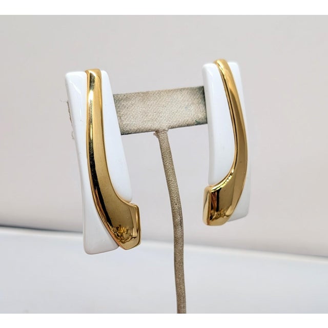 1980s Modernist goldtone and white resin with goldtone curved line pierced earrings with clip to keep them in place....