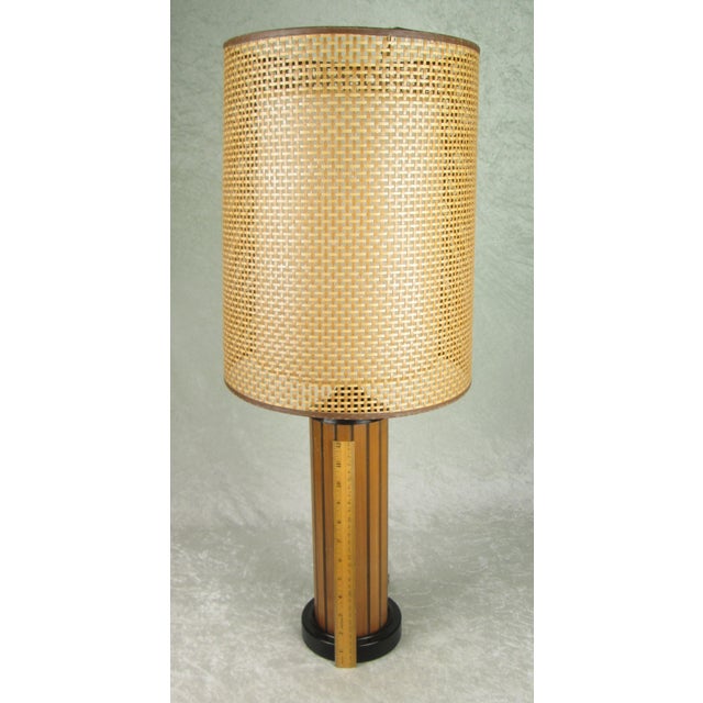 Vintage mid century modern table lamp by Gruvwood. The lamp has a vertical walnut body and black base and body cap with...
