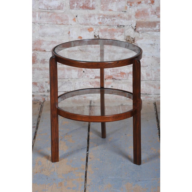 This shape-captivating and airily conceived side table in the distinct Art Deco style dates from the 1930s in...