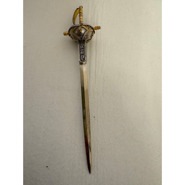 A striking vintage miniature Spanish rapier sword letter opener, meticulously crafted in Toledo, Spain, in the 1960's. A...