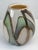 A distinctive hand-blown art glass vase featuring a sophisticated blend of cream, green, and brown tones in a modern...