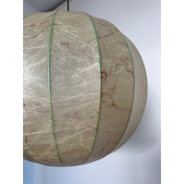 This is a Goldkant Leuchten Cocoon Pendant light from Germany circa 1970. There are dark maroon colored fibers throughout...