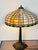 Elegant antique Tiffany Studios style table lamp. Bronze base for two bulbs, glass polychrome stained glass shade....