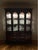 Elegant traditional china cabinet featuring a rich cherry-toned wood finish, beautiful crown molding, and classic...
