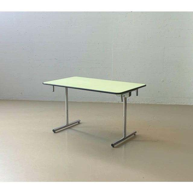 This original kelko folding table impresses with its ingenious folding mechanism and clean, functional design. With just a...
