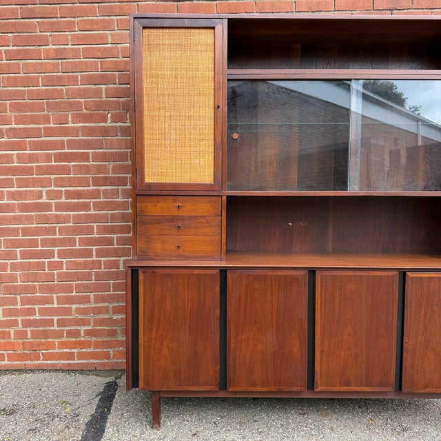 Designed by Merton Gershun for Dillingham’s Esprit collection, this mid-century modern two-piece credenza and hutch...